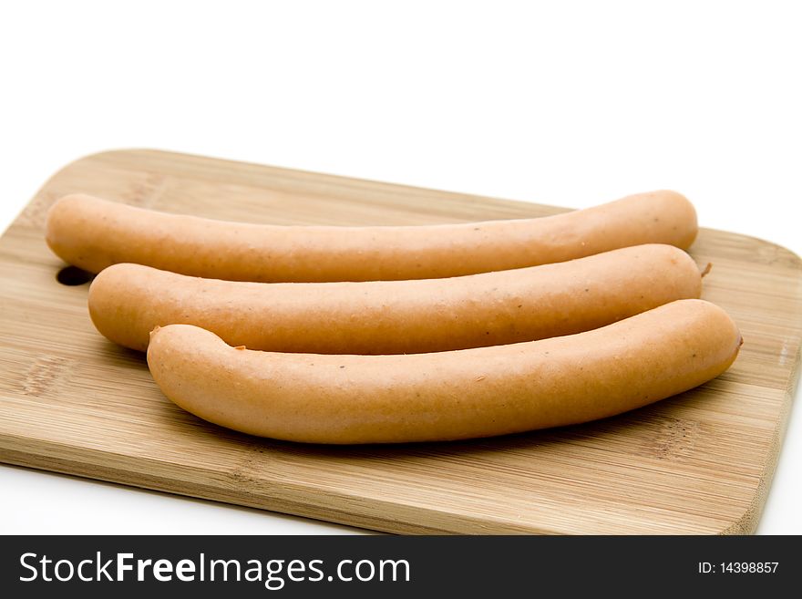 Raw sausages on edge board