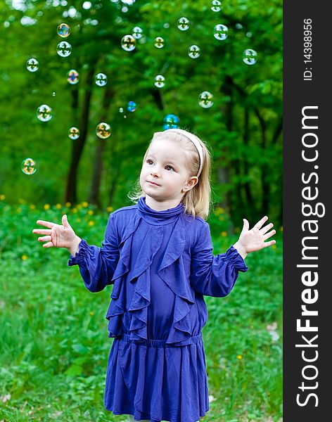Little girl in park with bubbles. Outdoor shot. Little girl in park with bubbles. Outdoor shot
