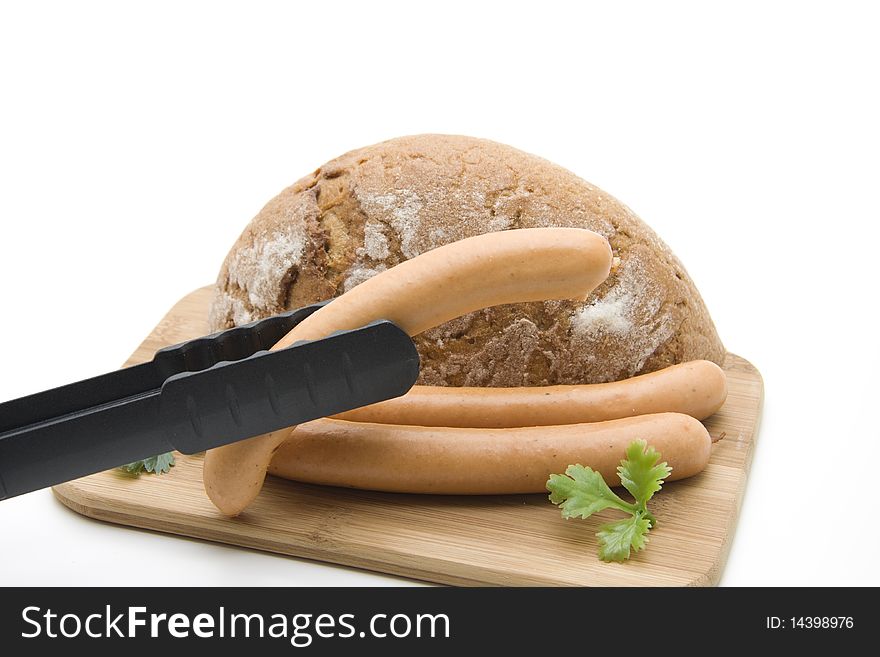 Sausage with and bread on edge board
