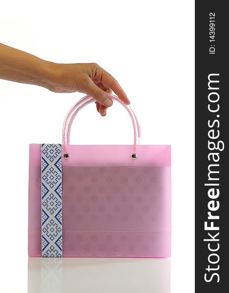 Female hand holds the small pink bag