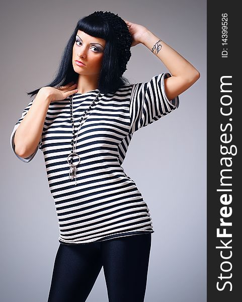 Attractive fashion woman posing in a striped top