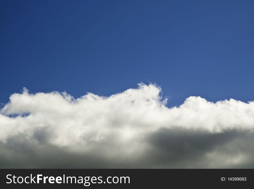 This image shows a blue sky with clouds half. This image shows a blue sky with clouds half