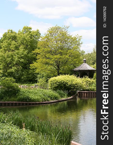 Beautiful lake on a sunny day with gardens and a gazebo. Beautiful lake on a sunny day with gardens and a gazebo.