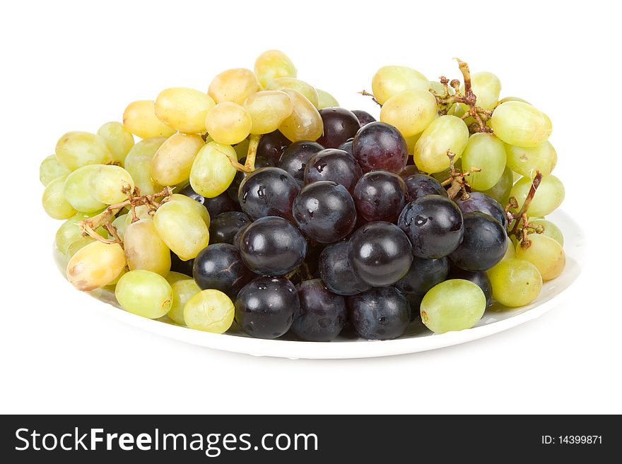 Plate with ripe grape insulated on white background