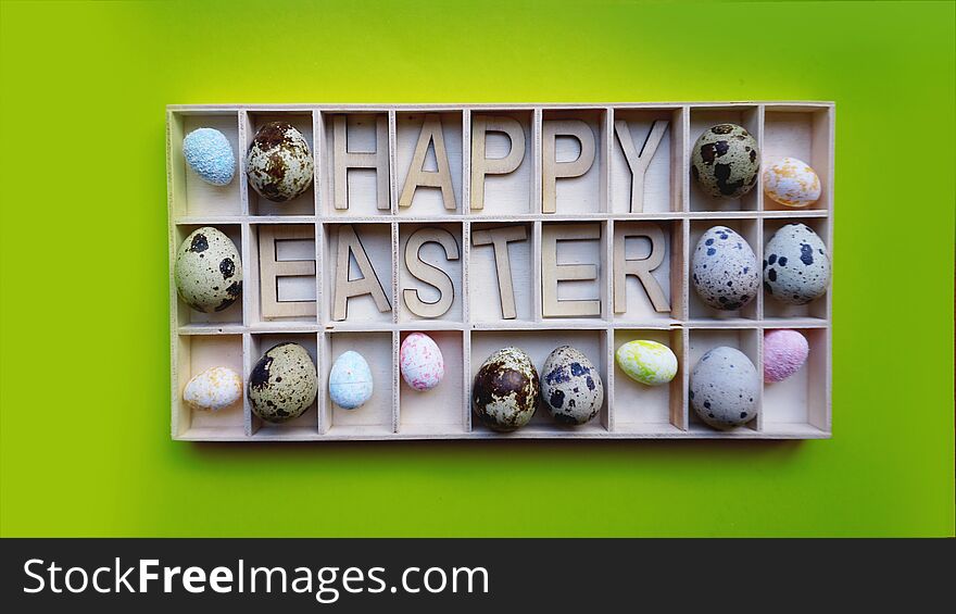 Easter eggs. Happy easter text. Holidays decoration green background. Decor elements in wooden containers