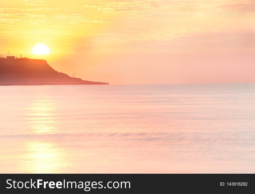 Dawn Of The Sea Bliss. Pink Water And The Sky, The Sun Rising From The Rocks.