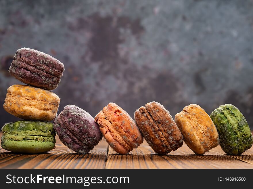 8 pcs moldy macaroons on a wood table