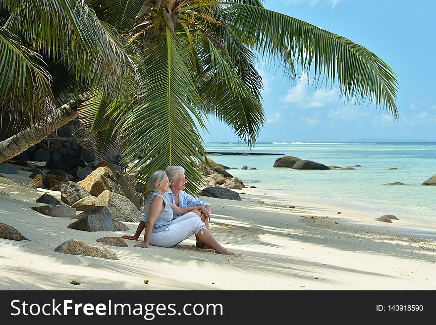 Happy elderly couple resting in tropical garden outdoors. Happy elderly couple resting in tropical garden outdoors