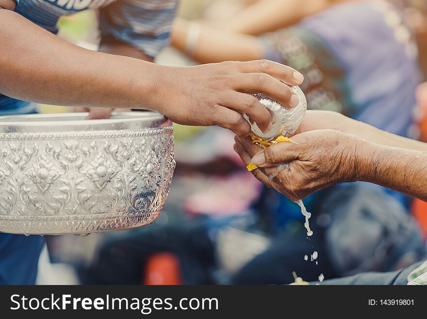 Thai people celebrate Songkran by pouring water and giving garlands to elder senior or respected grandparents and elder and asked for blessings for celebrate Songkran in new year water festival