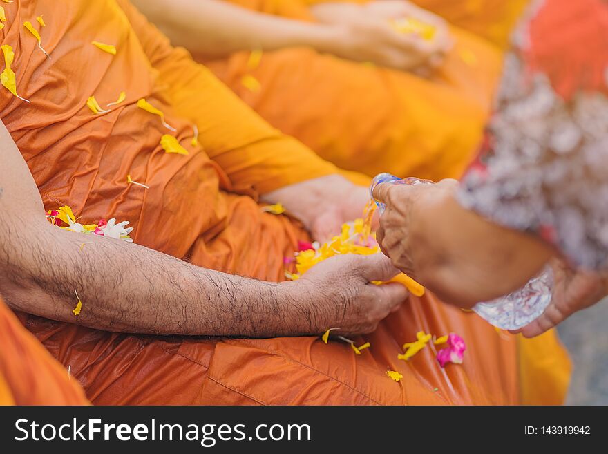 People pouring water to Buddhist Monk and gives blessing in Thailand Songkran annual festival