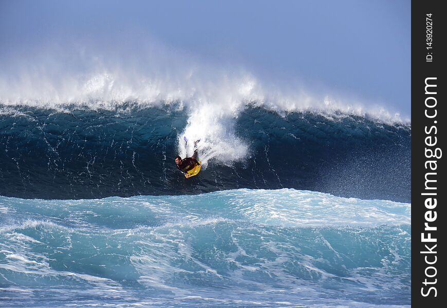 Surfer riding huge Atlantic waves
