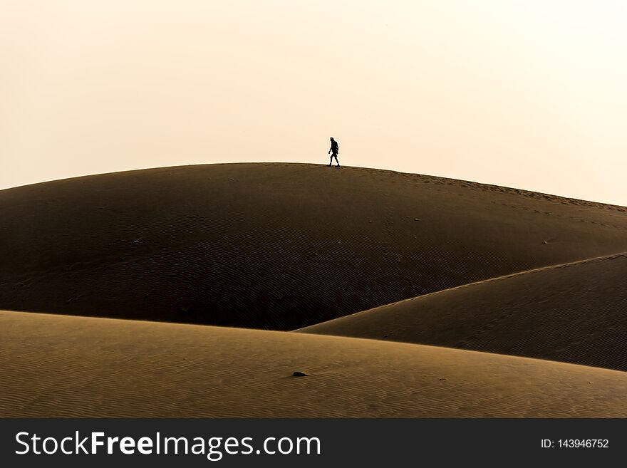 Men Walking In The Desert Of Gran Canaria, Spain