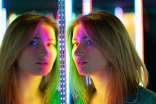 Sweet Caucasian Girl Walks In A Mirror Maze With Colorful Diodes And Enjoys An Unusual Attraction Room In The City Royalty Free Stock Photos