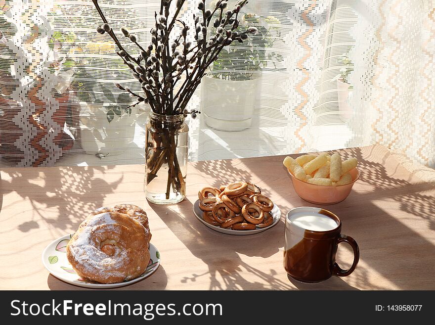 A Mug Of Milk, A Cup Of Corn And Cake On A Sunny Table, A Bouquet Of Spring Flowers For Mood,