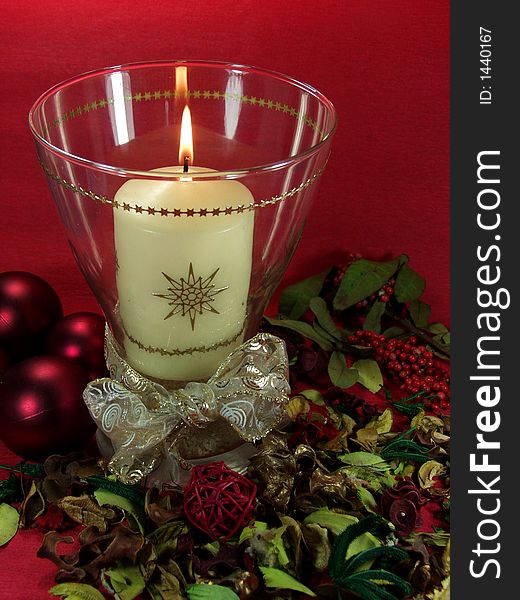 Christmas decoration whit candle, balls and flowers on red