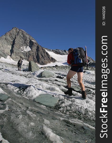 Climber with heavy backpack walking on glacier. Climber with heavy backpack walking on glacier