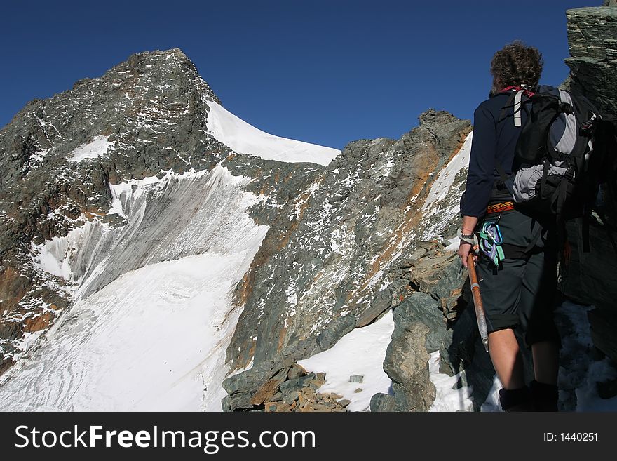 Climber on a mountain ridge in the Alps. Climber on a mountain ridge in the Alps