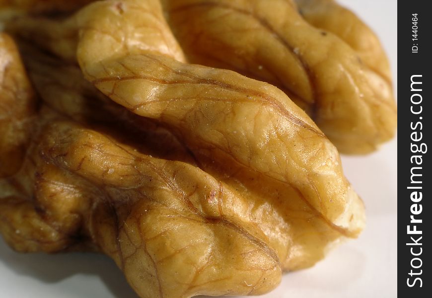 Close-up of a walnut against white background. Close-up of a walnut against white background