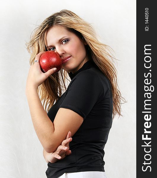 Young Beautiful Woman With Red Apple On The White