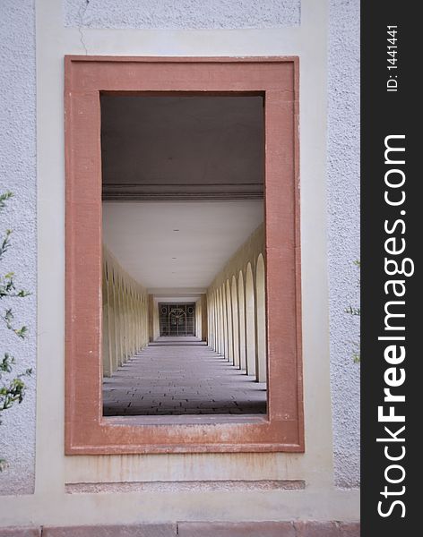 Looking through a window frame you can see  a 17th century colonnade at a chateau in the south-west of Germany. Looking through a window frame you can see  a 17th century colonnade at a chateau in the south-west of Germany.