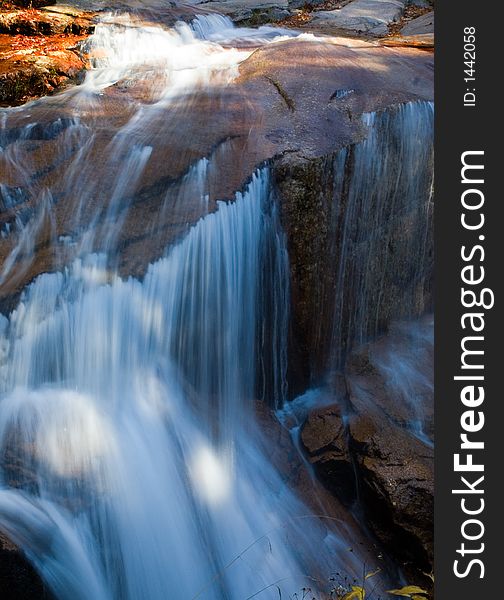 Water falls over boulders at gorge falls. Water falls over boulders at gorge falls.