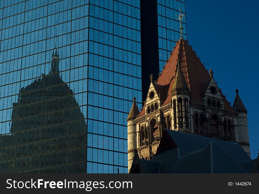 An old building is mirrored by another in a modern skyscraper. An old building is mirrored by another in a modern skyscraper.