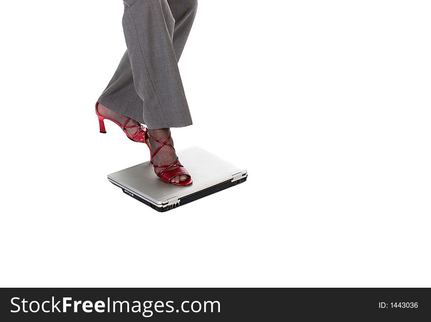 Business woman steps on laptop computer as if it were a stepping stone. Business woman steps on laptop computer as if it were a stepping stone.