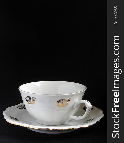 Porcelain cup of cappuccino on black background