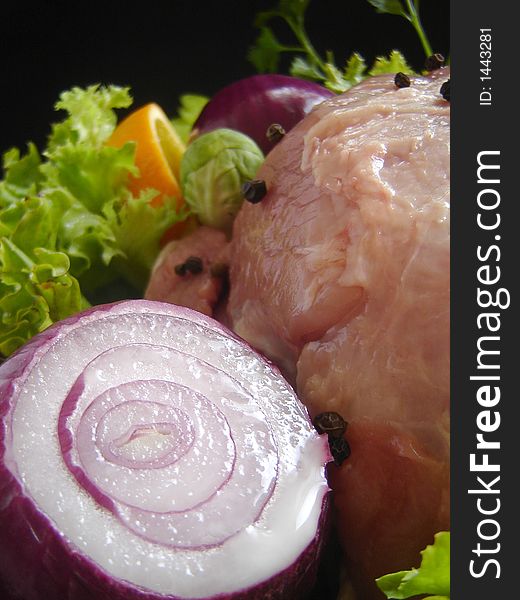 Fresh pork meat garnished with lettuce, purple onion, orange slice, apple and parsley. Fresh pork meat garnished with lettuce, purple onion, orange slice, apple and parsley