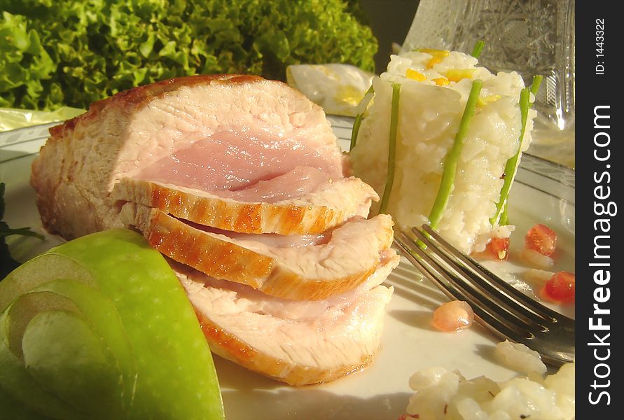Roast pork served with risotto garnish and decorated with apple and lettuce. Roast pork served with risotto garnish and decorated with apple and lettuce