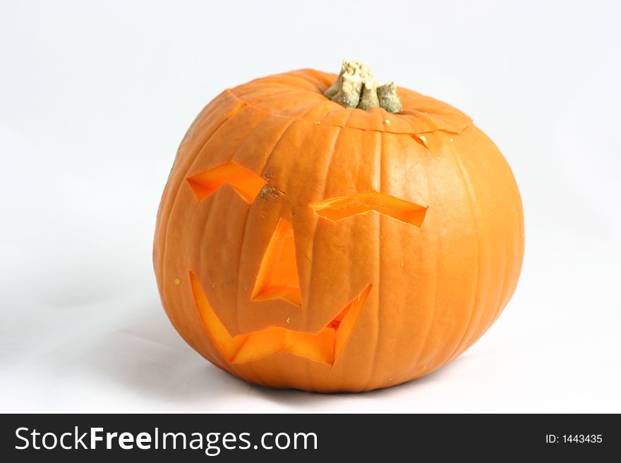 Cutout face in a pumpkin lit for halloween. Cutout face in a pumpkin lit for halloween