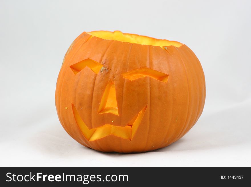 Cutout face in a pumpkin lit for halloween. Cutout face in a pumpkin lit for halloween