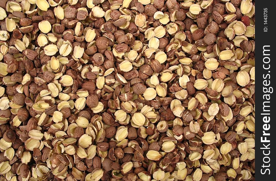 Many small brown dried nuts from Chinese market in macro close-up