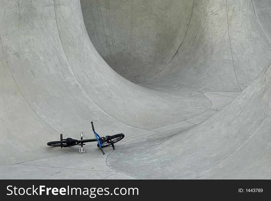 Bmx on the ground in skate bowl. Bmx on the ground in skate bowl