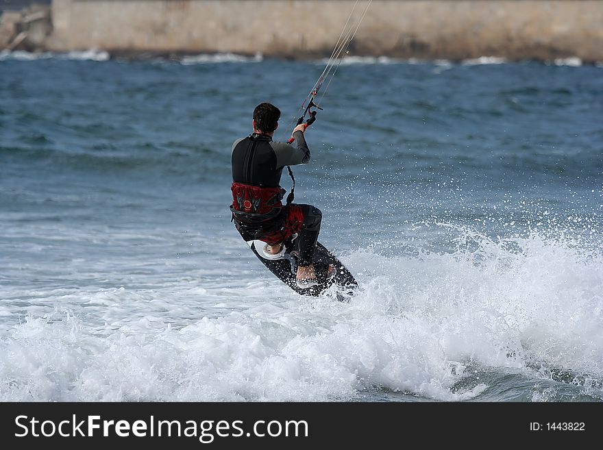 Kitesurfer jumping in the sea