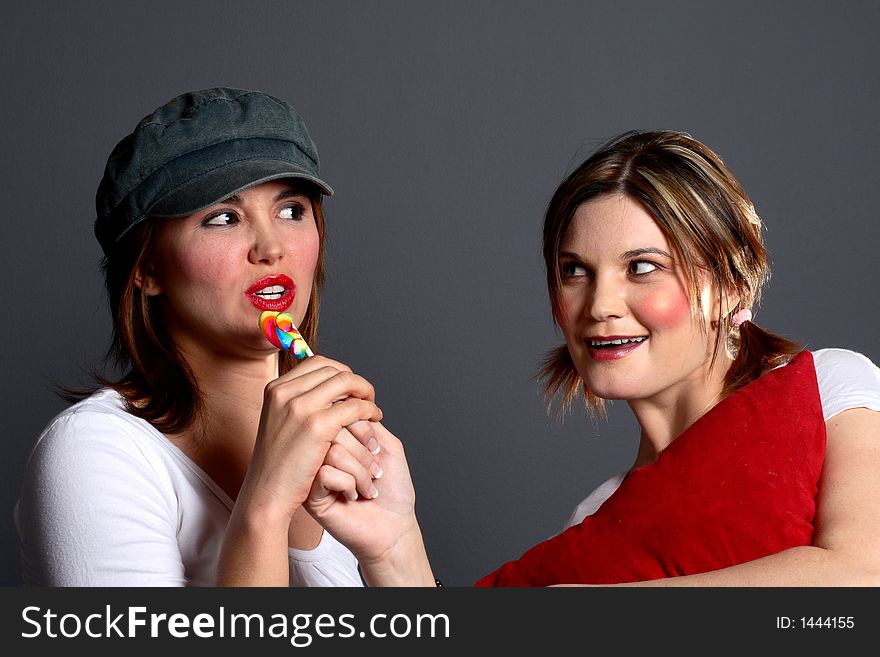 Two models one with a cap and the other dressed as a child. Two models one with a cap and the other dressed as a child