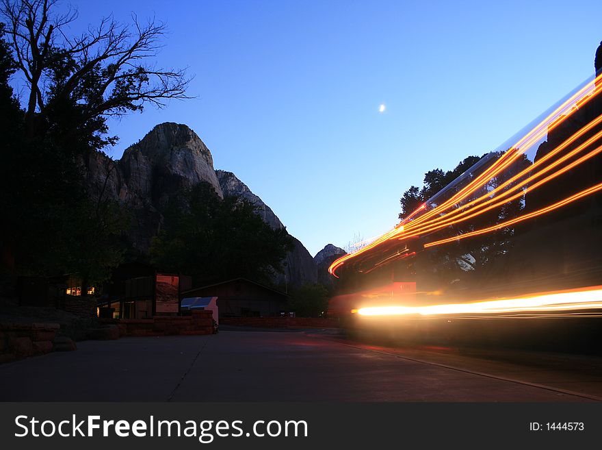 A bus turn in as the sun goes down and moon goes up in zion canyon national park. A bus turn in as the sun goes down and moon goes up in zion canyon national park