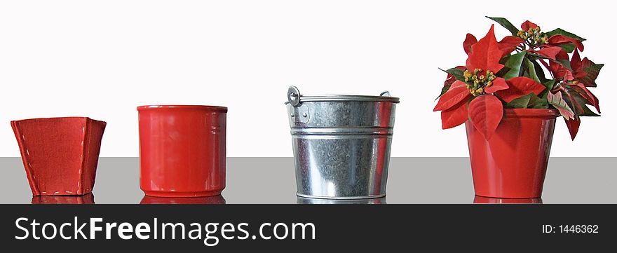 Four pots from different material for the Christmas decoration, one pot is planted with an artificial plant. Four pots from different material for the Christmas decoration, one pot is planted with an artificial plant