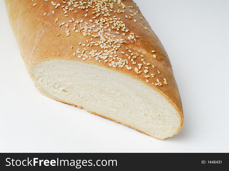 Close up of cut end of a loaf of French bread with sesame seed topping. Close up of cut end of a loaf of French bread with sesame seed topping