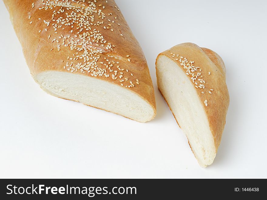 Sliced loaf of French bread with sesame seed topping. Sliced loaf of French bread with sesame seed topping