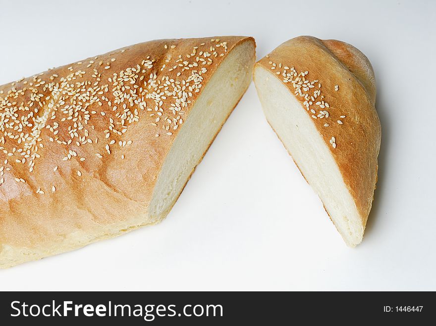 Sliced loaf of French bread with sesame seed topping. Sliced loaf of French bread with sesame seed topping