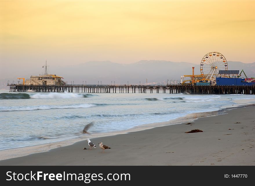 A shot of the santa monica pier at sunrise