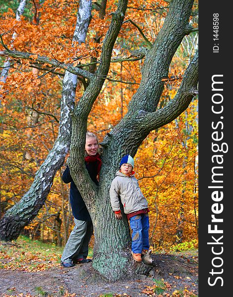 Mother and san in an autumn wood