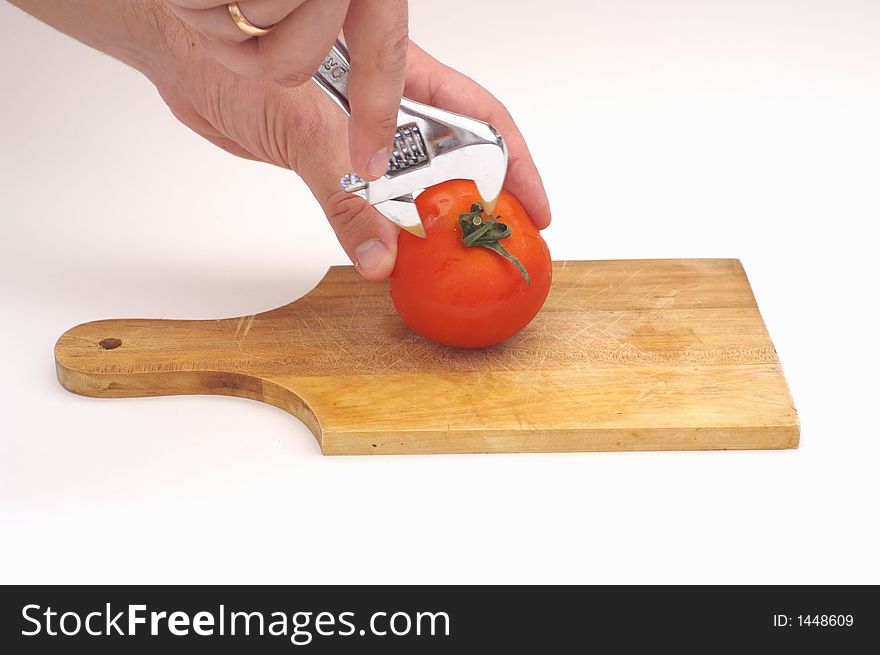 a tomato on a wooden plate. a tomato on a wooden plate