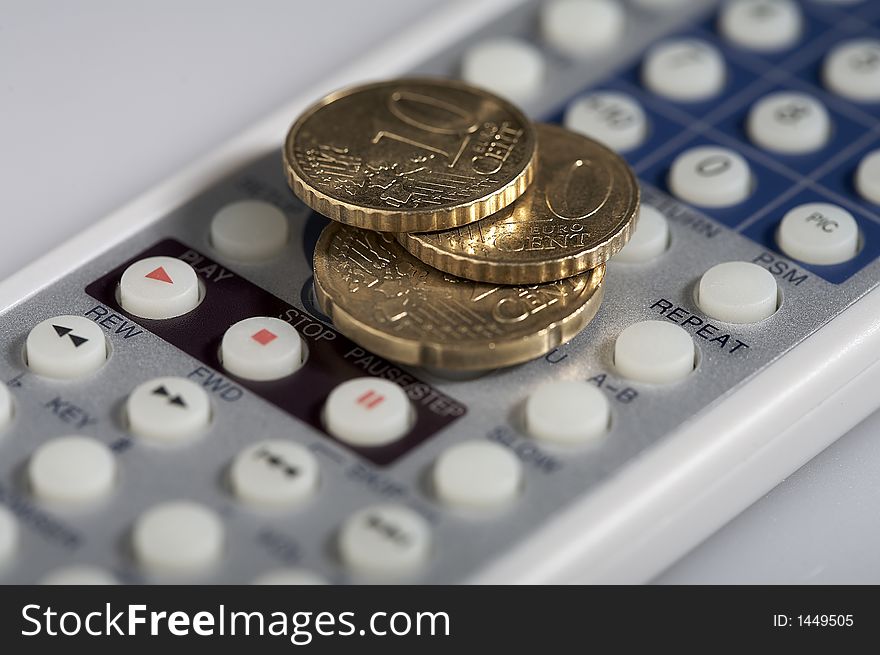 Eur coins lying on a remote control