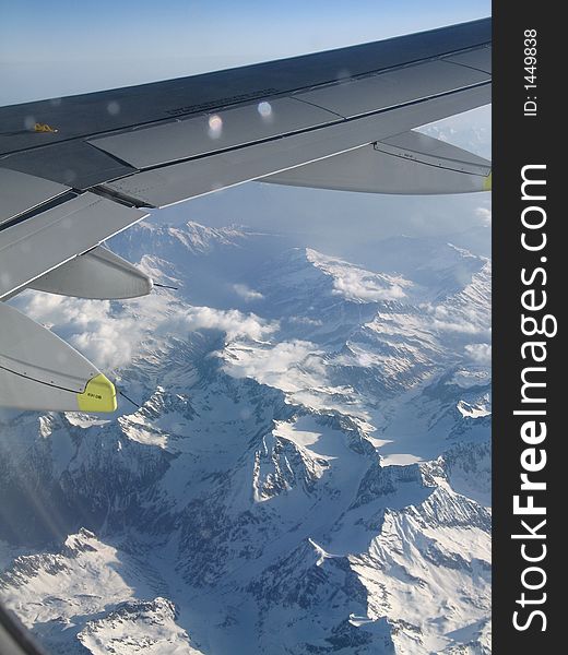 View of the airplane's wing of Alpes in Switzerland. View of the airplane's wing of Alpes in Switzerland