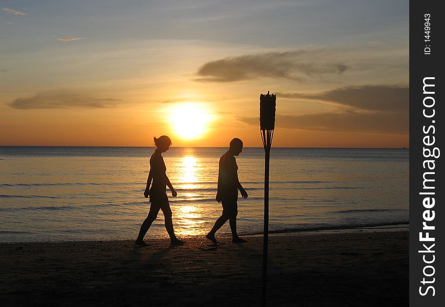 Two people walking on beach in Thailand at Sunset. Koh Chang. Two people walking on beach in Thailand at Sunset. Koh Chang