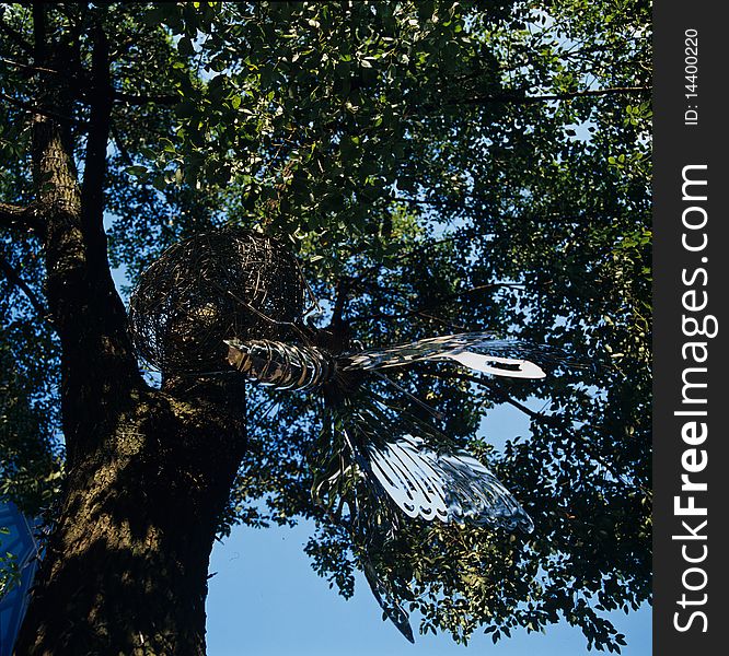 A big metal butterfly hung on the tree