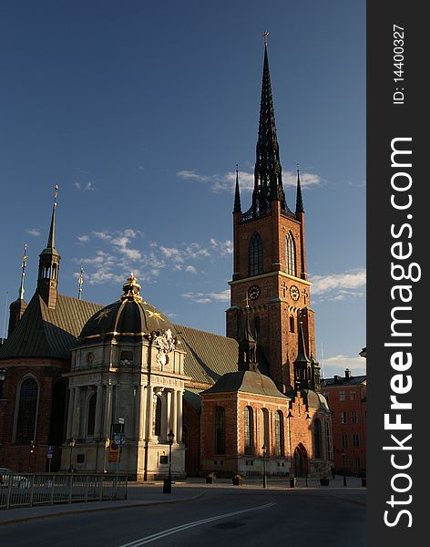 Old Riddarholmskyrkan in sunset light with blue sky. Old Riddarholmskyrkan in sunset light with blue sky