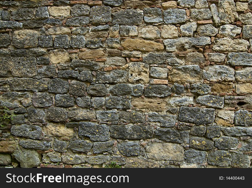 A wall of aged stones in line. A wall of aged stones in line